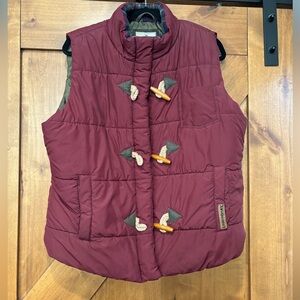 Burgundy vest with wood buttons.